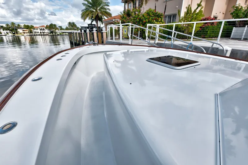 "double Down" Yacht Photos Pics 2014 Release Walkaround boat docked by waterfront with palm trees and cloudy sky.