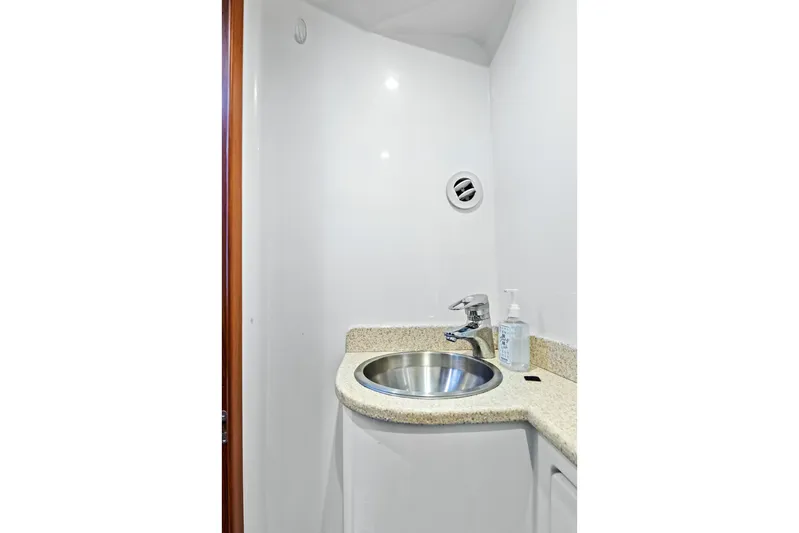 "double Down" Yacht Photos Pics Compact boat bathroom with stainless steel sink, granite countertop, and soap dispenser, 2014 Release Walkaround.