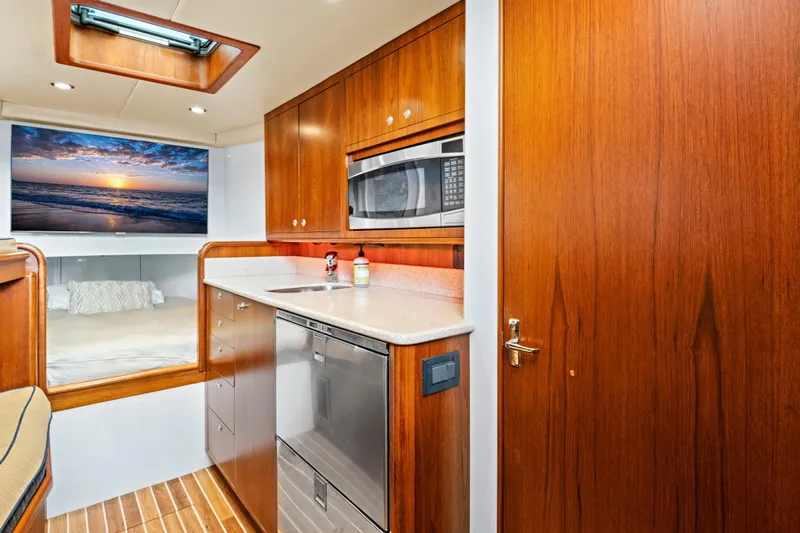 "double Down" Yacht Photos Pics Luxurious 2014 Release Walkaround yacht interior with wood cabinetry and modern appliances.