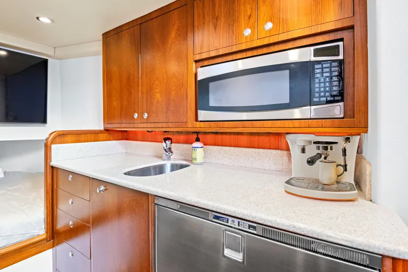 "double Down" Yacht Photos Pics 2014 Release Walkaround yacht kitchen with microwave, espresso machine, and wooden cabinetry.