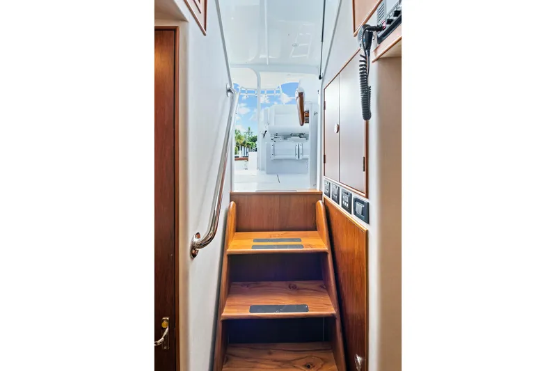 "double Down" Yacht Photos Pics Staircase inside 2014 Release Walkaround boat, leading to upper deck with wooden finish.