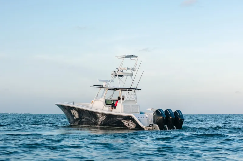  Yacht Photos Pics 2023 Front Runner 36 Center Console boat on open water, featuring triple outboard engines.