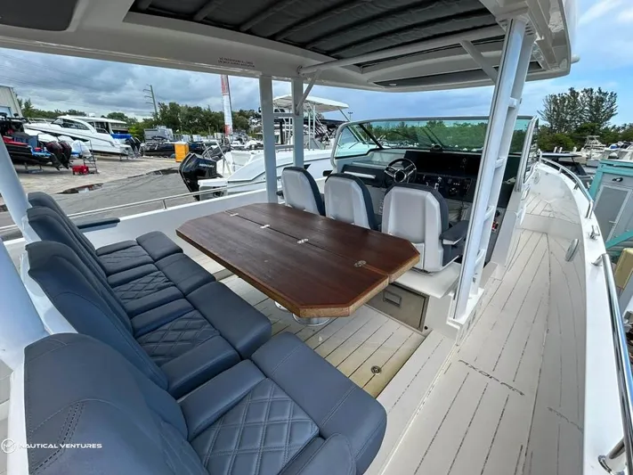  Yacht Photos Pics 2018 Axopar 37 Sun Top boat interior with seating and table.
