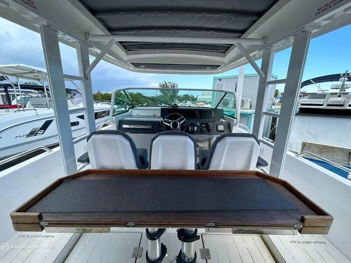  Yacht Photos Pics 2018 Axopar 37 Sun Top boat interior with helm and seating.