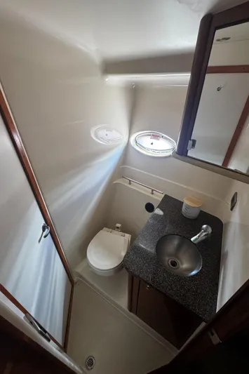  Yacht Photos Pics 2006 Sea Ray 380 Sundancer bathroom with sink, toilet, and porthole window.