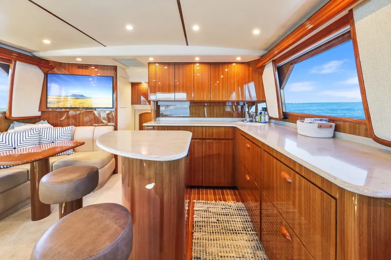 Trouble Maker Yacht Photos Pics Luxurious interior of 2013 Viking 46 Convertible yacht with elegant wood finishes and ocean view.