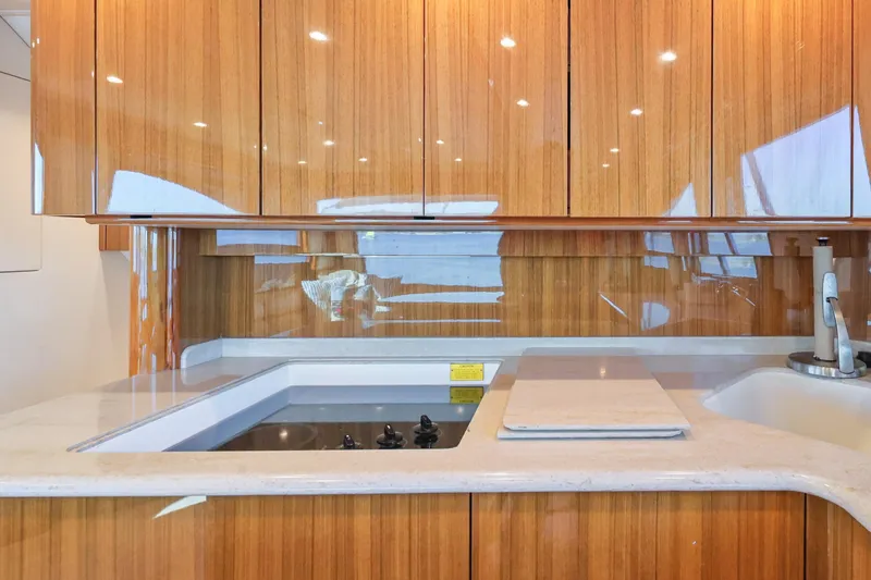 Trouble Maker Yacht Photos Pics Luxurious kitchen interior of 2013 Viking 46 Convertible yacht with wooden cabinetry.