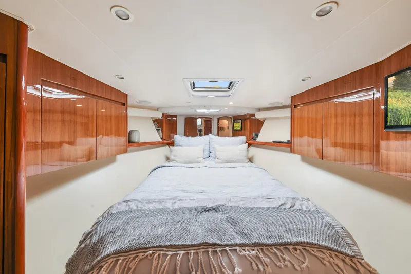 Trouble Maker Yacht Photos Pics Luxurious interior of 2013 Viking 46 Convertible yacht with cozy bed and wooden cabinetry.