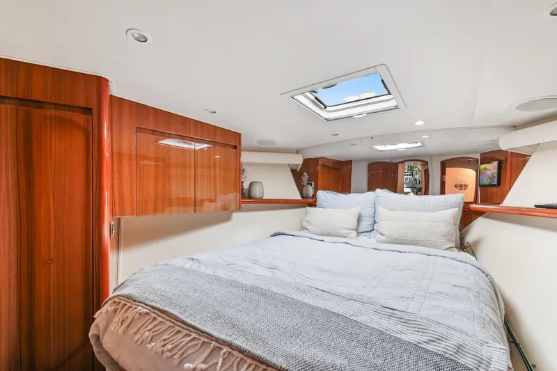 Trouble Maker Yacht Photos Pics Luxurious bedroom interior of 2013 Viking 46 Convertible yacht with skylight and wooden cabinetry.