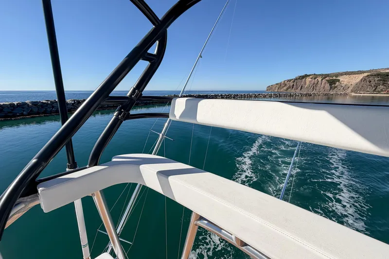 Trouble Maker Yacht Photos Pics 2013 Viking 46 Convertible yacht navigating coastal waters with scenic cliff view.