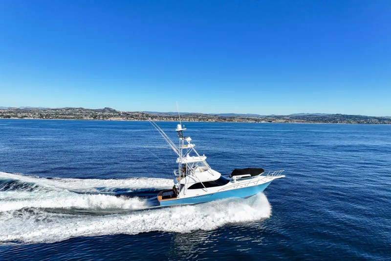 Trouble Maker Yacht Photos Pics 2013 Viking 46 Convertible yacht cruising on open blue sea.