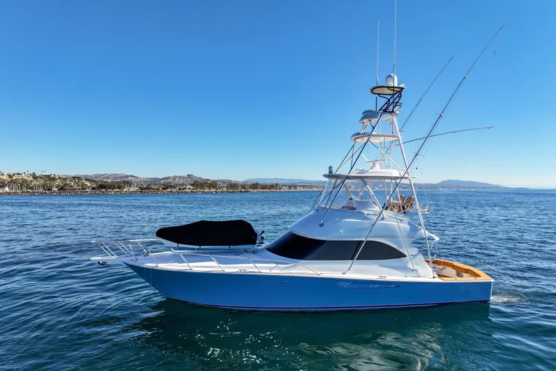 Trouble Maker Yacht Photos Pics 2013 Viking 46 Convertible yacht on calm ocean waters under clear blue sky.