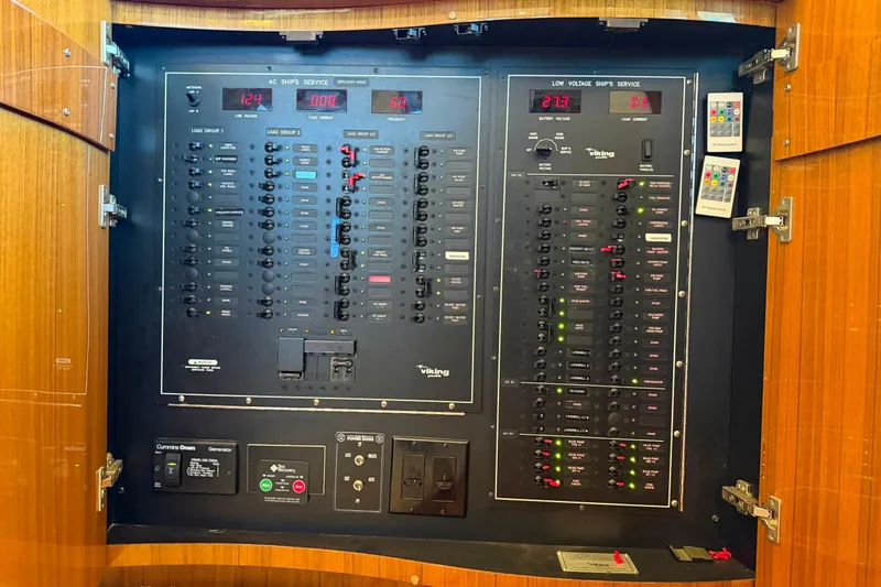 Trouble Maker Yacht Photos Pics Electrical control panel inside a 2013 Viking 46 Convertible yacht, featuring various switches and indicators.