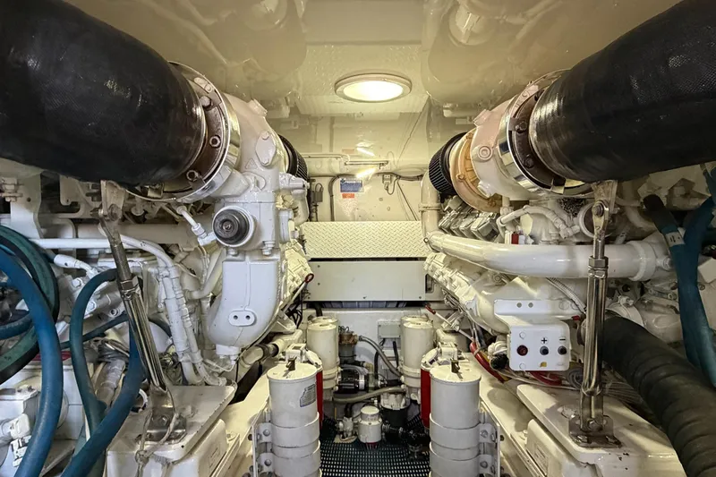 Trouble Maker Yacht Photos Pics Engine room of 2013 Viking 46 Convertible yacht, showcasing powerful machinery and components.