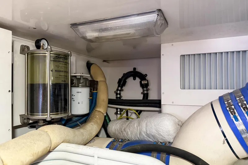Trouble Maker Yacht Photos Pics Engine room of 2013 Viking 46 Convertible yacht, showing power steering and filtration systems.