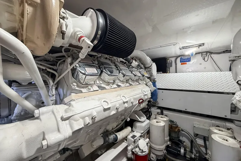 Trouble Maker Yacht Photos Pics Engine room of 2013 Viking 46 Convertible yacht, showcasing detailed machinery and components.
