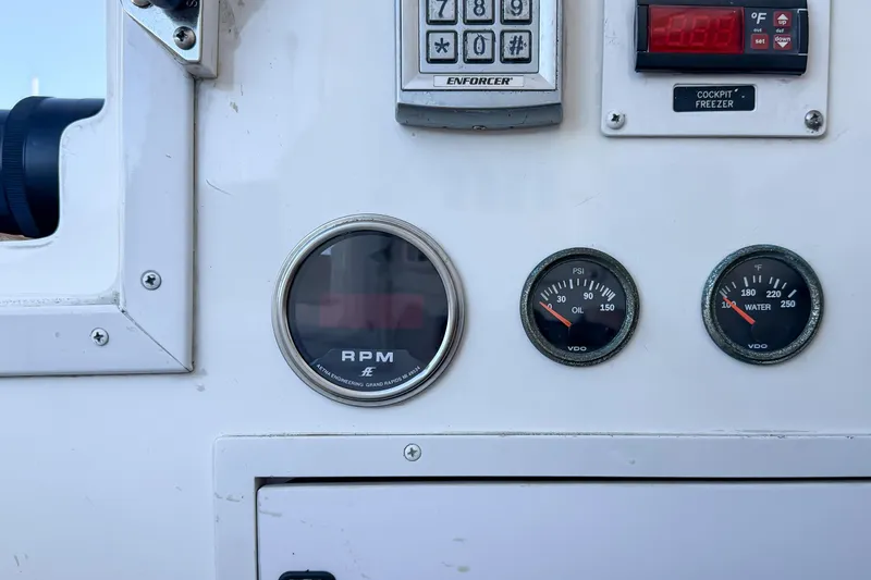 Trouble Maker Yacht Photos Pics Control panel of a 2013 Viking 46 Convertible boat with gauges and keypad.