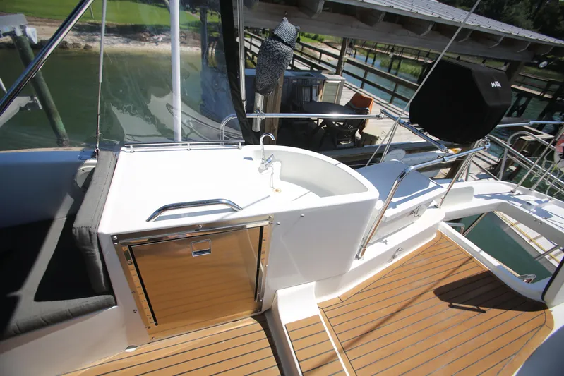 Gracie May Yacht Photos Pics 2007 Beneteau Swift Trawler 42 deck with wood flooring and outdoor sink.