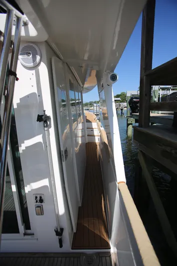 Gracie May Yacht Photos Pics 2007 Beneteau Swift Trawler 42 side deck with wooden flooring and white exterior.