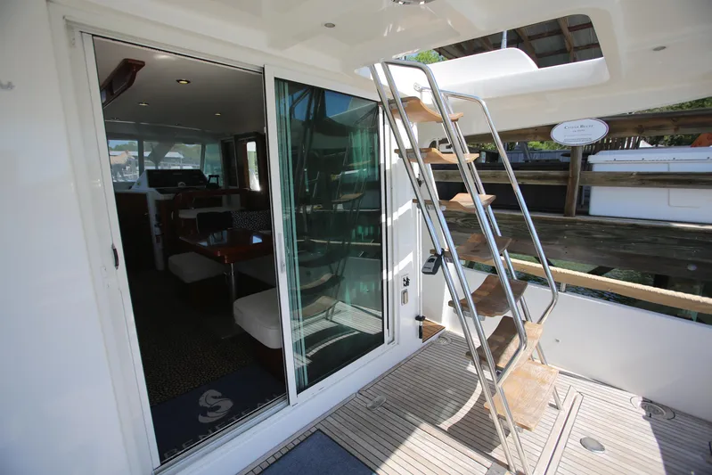 Gracie May Yacht Photos Pics 2007 Beneteau Swift Trawler 42 interior view with ladder and sliding glass door.