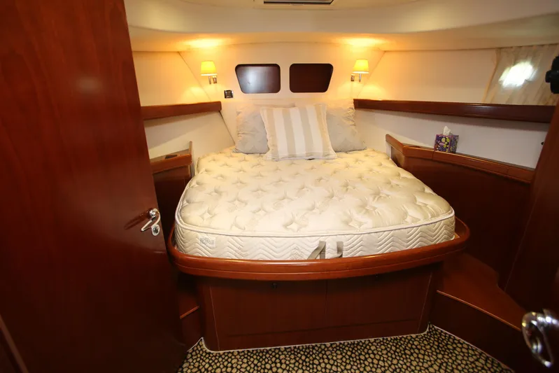 Gracie May Yacht Photos Pics 2007 Beneteau Swift Trawler 42 cabin with cozy bed and warm lighting.