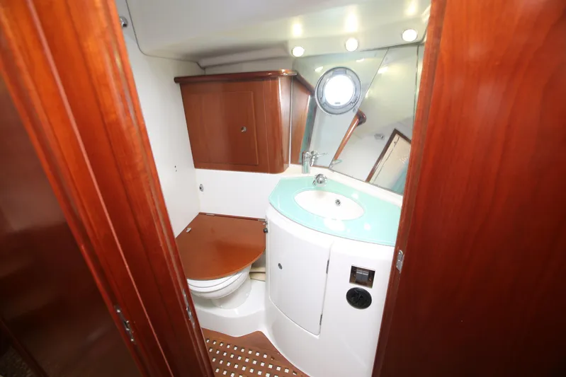 Gracie May Yacht Photos Pics 2007 Beneteau Swift Trawler 42 bathroom with wooden cabinetry and modern fixtures.