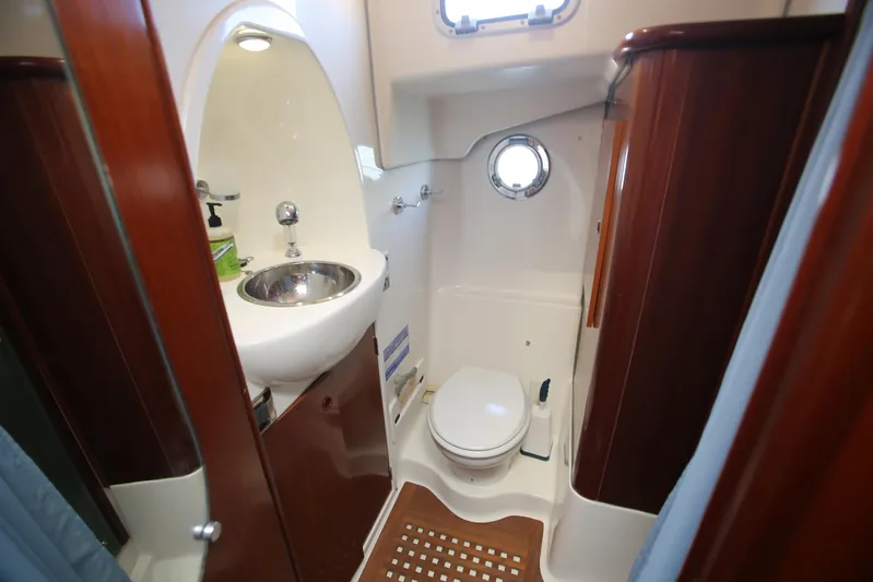 Gracie May Yacht Photos Pics 2007 Beneteau Swift Trawler 42 bathroom with sink, toilet, and porthole window.
