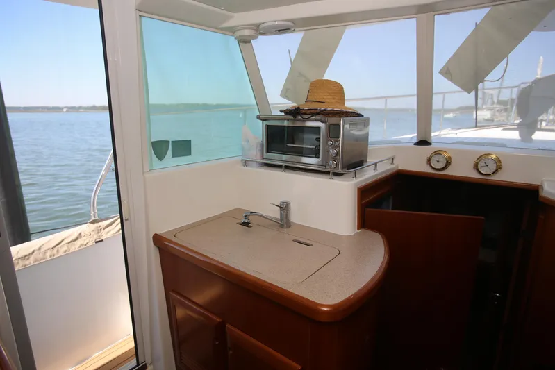 Gracie May Yacht Photos Pics 2007 Beneteau Swift Trawler 42 interior with kitchenette, microwave, and scenic water view.