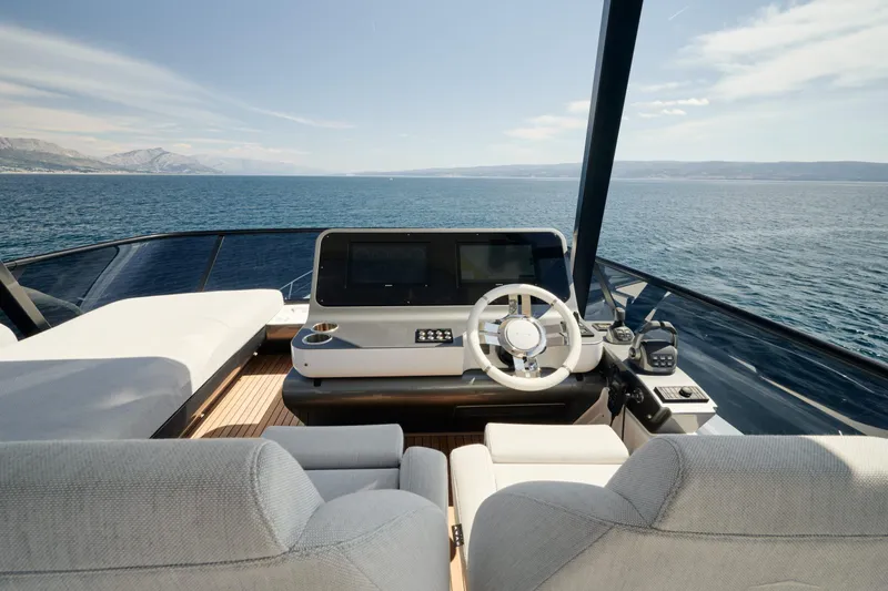  Yacht Photos Pics Luxurious 2022 Azimut 68 Hard Top yacht helm with stunning ocean view.