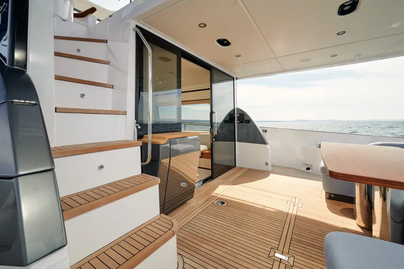  Yacht Photos Pics Luxurious 2022 Azimut 68 Hard Top yacht interior with elegant wood flooring and ocean view.