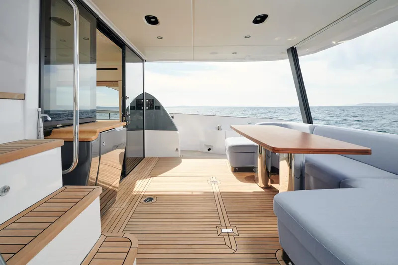  Yacht Photos Pics Luxurious 2022 Azimut 68 Hard Top yacht interior with elegant wood flooring and ocean view.