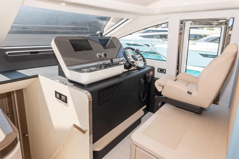  Yacht Photos Pics Interior helm of 2022 Azimut 68 yacht with modern controls and luxurious seating.