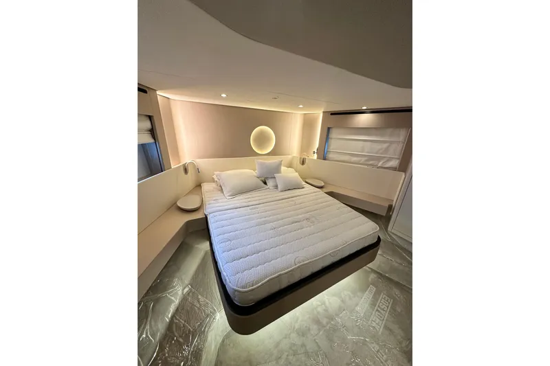  Yacht Photos Pics Luxurious bedroom interior of 2022 Azimut 68 yacht with modern design and ambient lighting.
