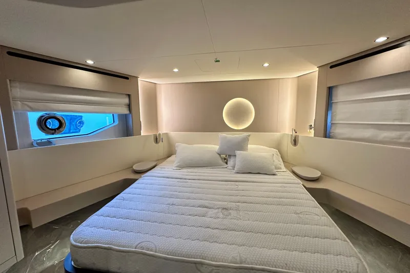  Yacht Photos Pics Luxurious bedroom interior of 2022 Azimut 68 yacht with modern design and ambient lighting.