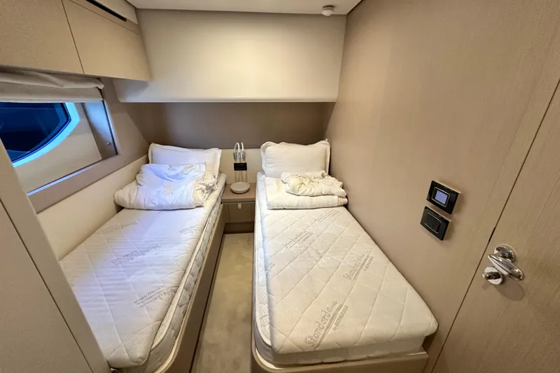  Yacht Photos Pics Luxurious twin cabin interior on 2022 Azimut 68 yacht, featuring modern design and comfort.