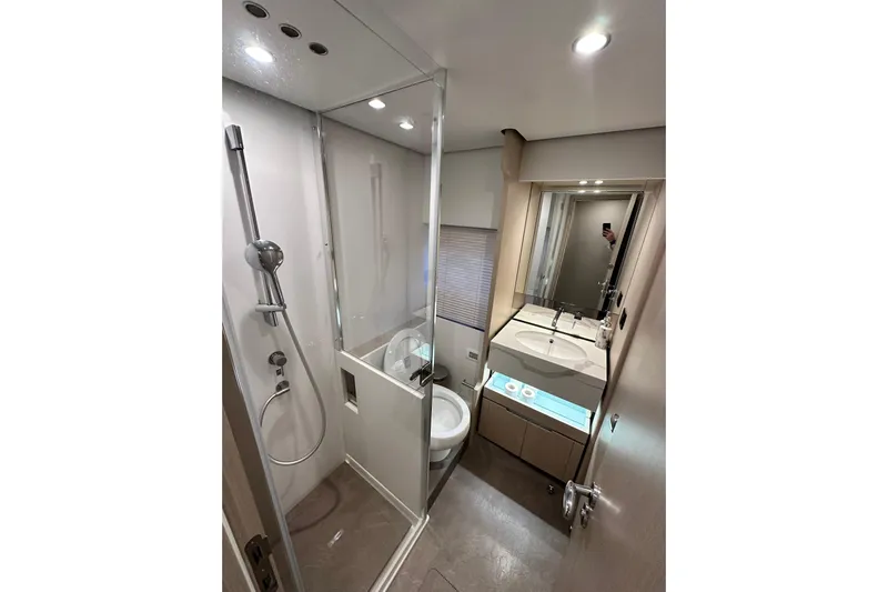  Yacht Photos Pics Luxurious bathroom in 2022 Azimut 68 yacht with modern shower and sleek vanity.