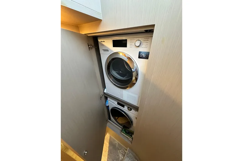  Yacht Photos Pics Stacked washer and dryer in 2022 Azimut 68 yacht interior.