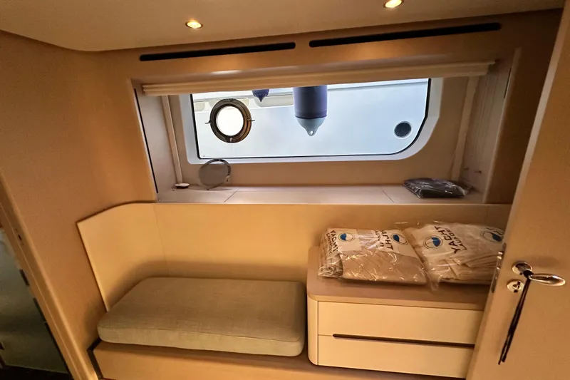  Yacht Photos Pics Interior of 2022 Azimut 68 yacht cabin with window and seating area.