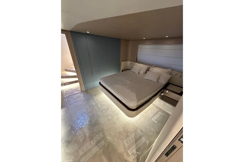  Yacht Photos Pics Luxurious bedroom interior of 2022 Azimut 68 yacht with modern design and ambient lighting.