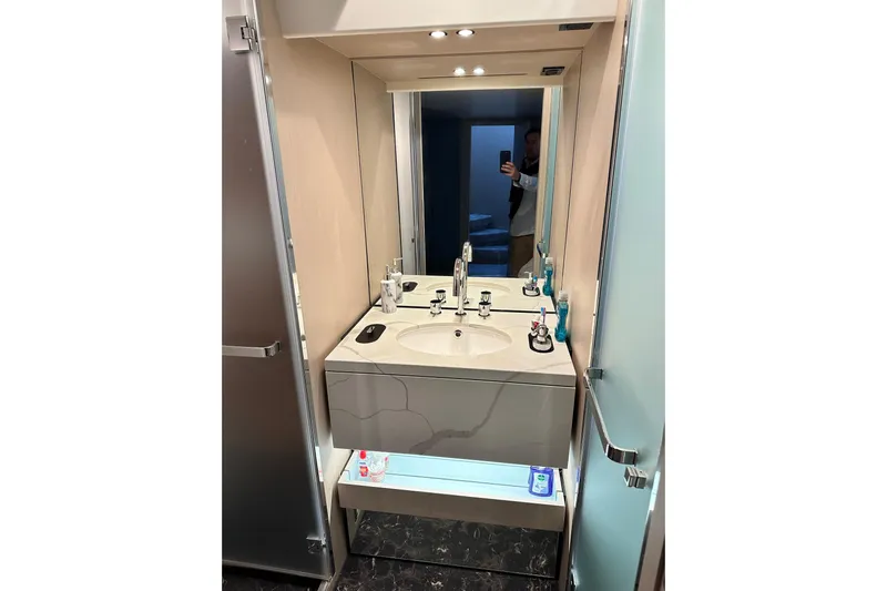  Yacht Photos Pics Modern bathroom vanity on 2022 Azimut 68 yacht, featuring sleek design and ample lighting.