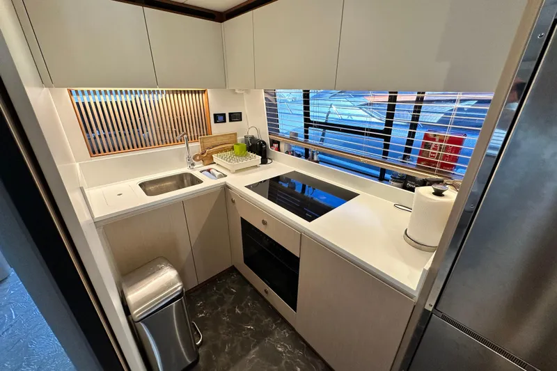  Yacht Photos Pics Modern kitchen in 2022 Azimut 68 yacht with sleek countertops and appliances.