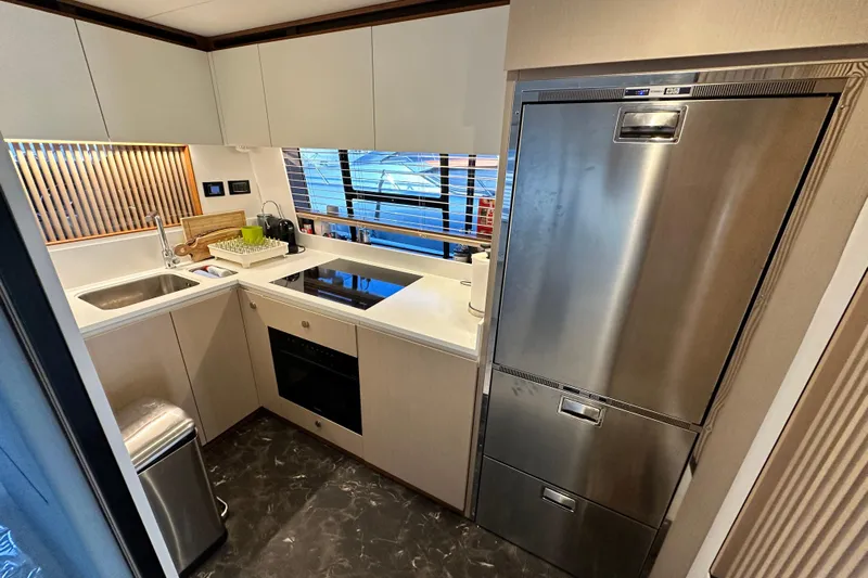  Yacht Photos Pics Modern kitchen interior on 2022 Azimut 68 yacht, featuring sleek appliances and stylish design.