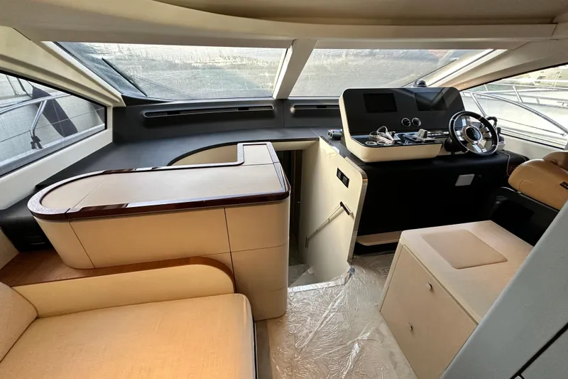  Yacht Photos Pics Luxurious interior of 2022 Azimut 68 yacht with modern helm and seating area.