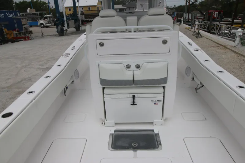  Yacht Photos Pics 2025 Invincible 33 Open Fisherman boat interior, featuring seating and storage compartments.