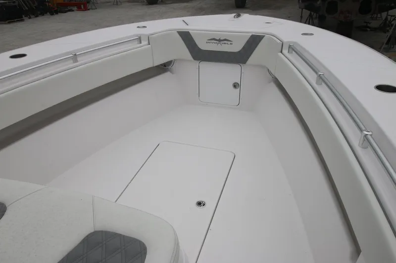 Yacht Photos Pics 2025 Invincible 33 Open Fisherman boat interior, featuring sleek white seating and storage.