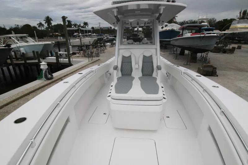  Yacht Photos Pics 2025 Invincible 33 Open Fisherman boat at a marina, showcasing spacious deck and seating.