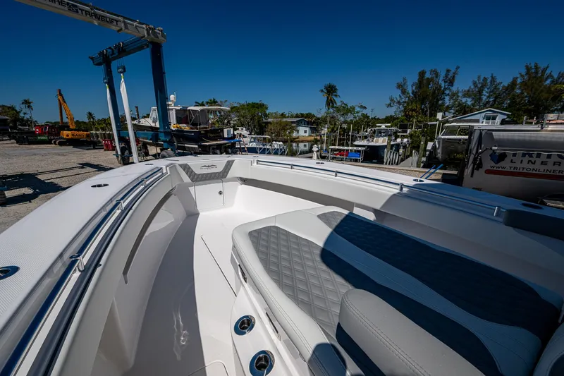  Yacht Photos Pics 2025 Invincible 33 Open Fisherman boat interior with seating, docked at marina.