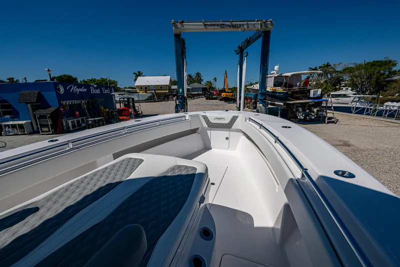  Yacht Photos Pics 2025 Invincible 33 Open Fisherman boat at a marina, showcasing spacious deck design.