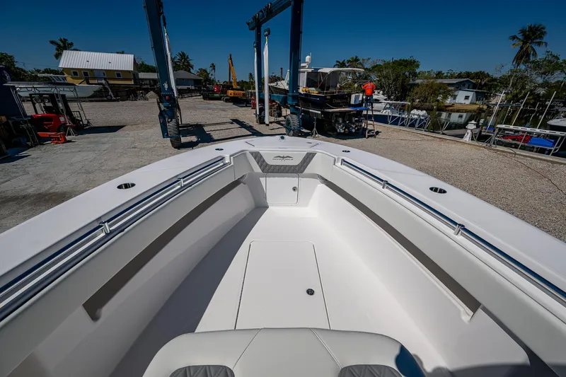  Yacht Photos Pics 2025 Invincible 33 Open Fisherman boat at a marina, showcasing spacious deck design.