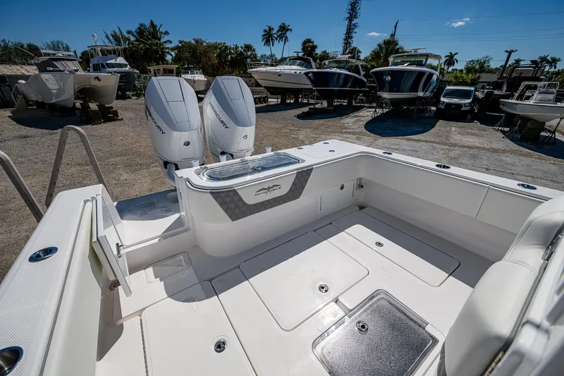  Yacht Photos Pics 2025 Invincible 33 Open Fisherman boat with dual engines, docked under a clear blue sky.